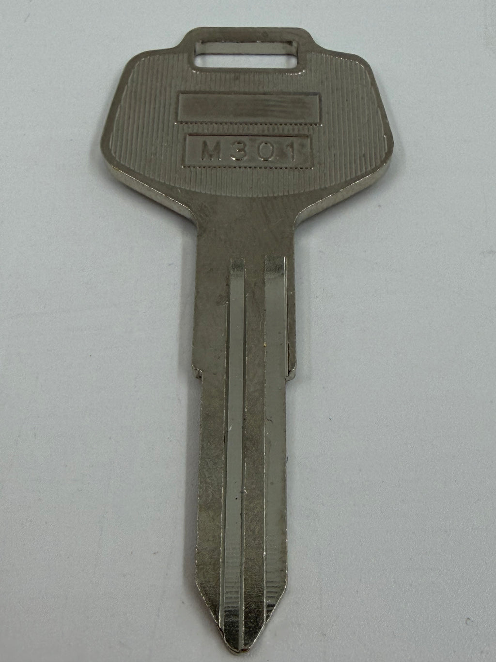 A single metal key with a textured head and a flat blade, featuring the stamped characters 'M301' on the keyway, shown against a plain light gray background.
